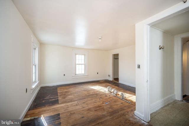 empty room with dark hardwood / wood-style floors