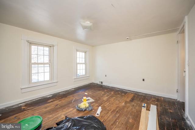 spare room with dark wood-type flooring