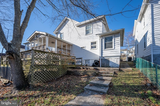 back of house with a deck