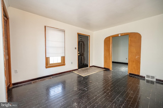 spare room with dark hardwood / wood-style flooring