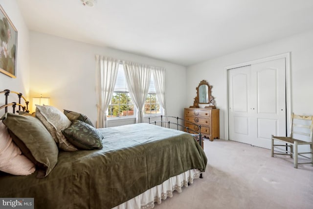 carpeted bedroom with a closet