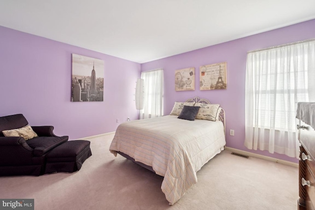 bedroom with light colored carpet