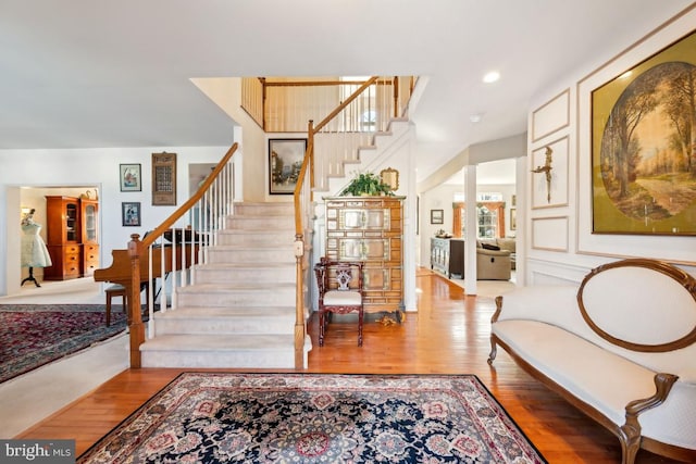 stairs featuring hardwood / wood-style floors