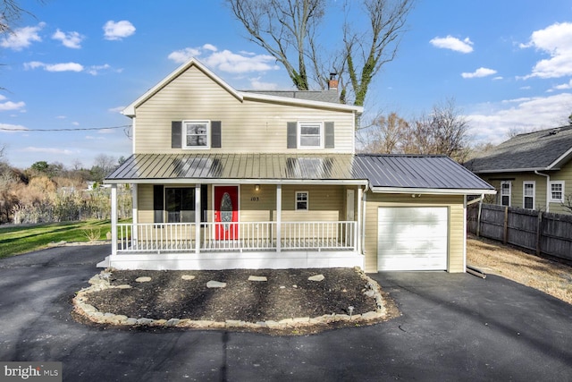 view of front of property featuring covered porch and a garage