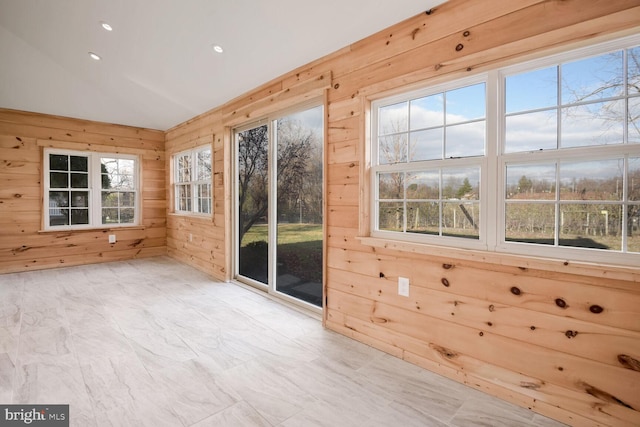 unfurnished sunroom featuring vaulted ceiling