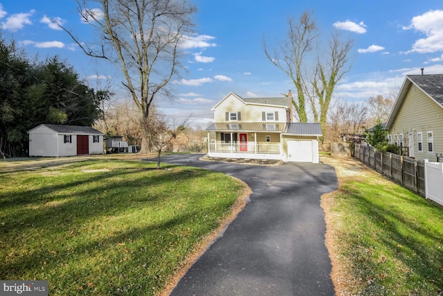 view of front of property with a porch, a garage, and a front lawn