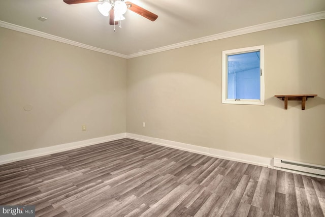 empty room featuring baseboard heating, hardwood / wood-style floors, and ornamental molding