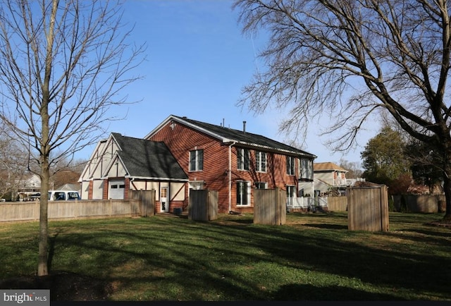 rear view of house with a yard