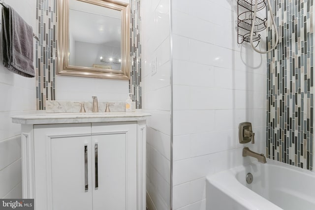 bathroom featuring vanity and tiled shower / bath