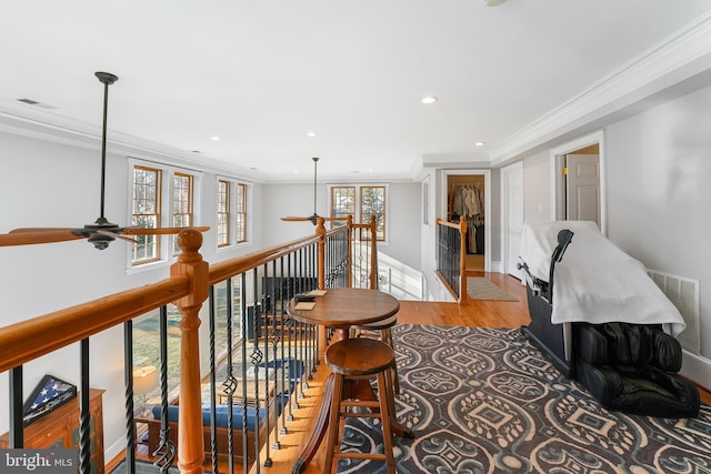 interior space with light wood-type flooring and crown molding