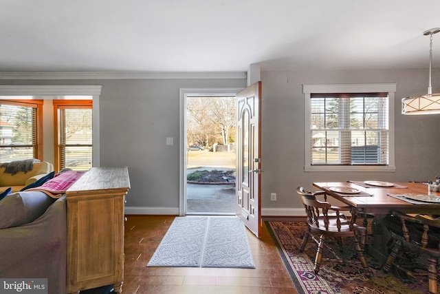 dining space with crown molding and dark hardwood / wood-style floors