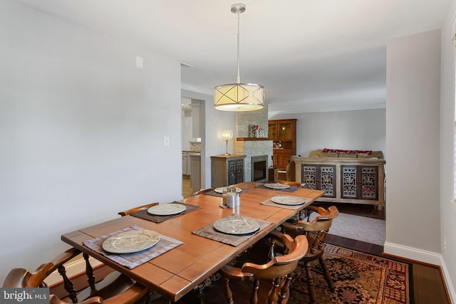 dining room with wood-type flooring and ornamental molding