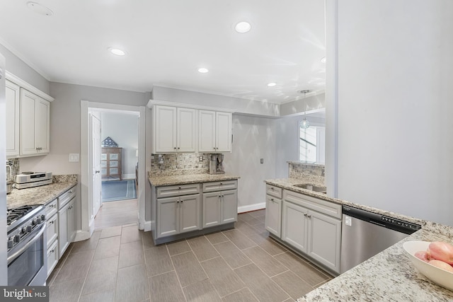 kitchen with light stone counters, white cabinets, and stainless steel appliances