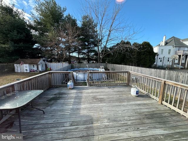 wooden deck with an outbuilding