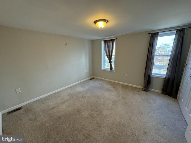 empty room featuring light carpet