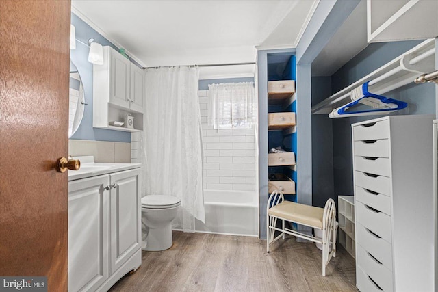 full bathroom featuring vanity, toilet, wood-type flooring, and shower / tub combo