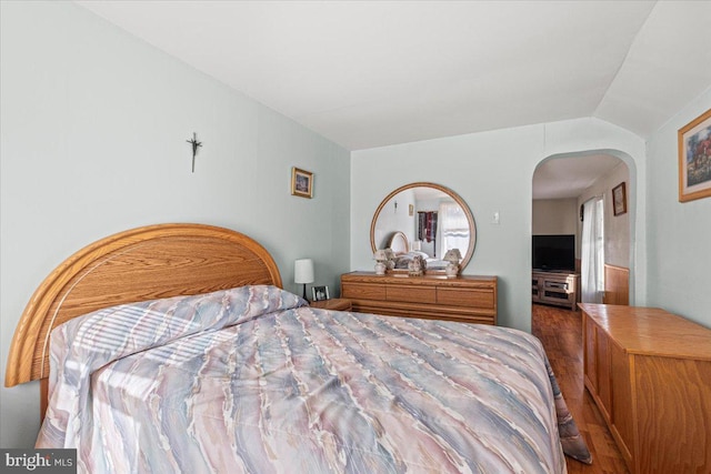 bedroom with hardwood / wood-style floors and vaulted ceiling