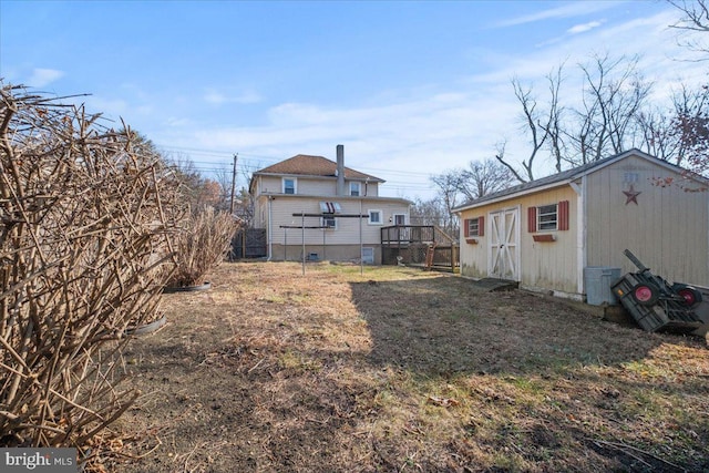 view of yard with a shed and a deck