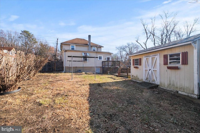 view of yard with a deck and a storage shed