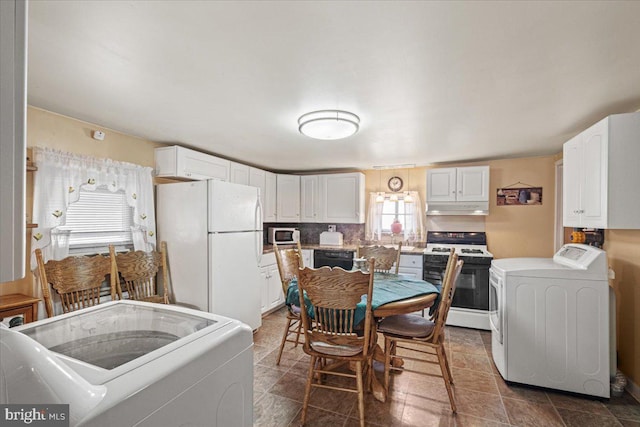 kitchen with white cabinets, white appliances, and washer / dryer