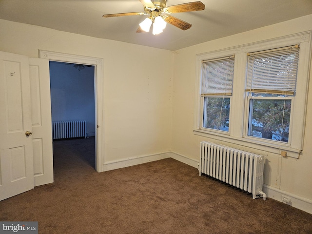 carpeted spare room with radiator heating unit and ceiling fan