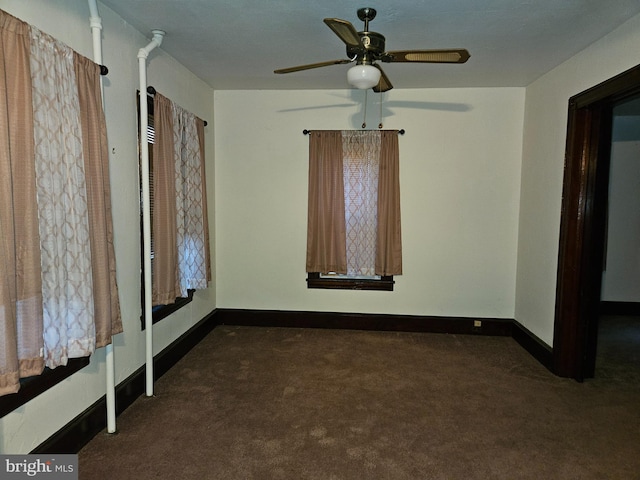 carpeted empty room featuring ceiling fan