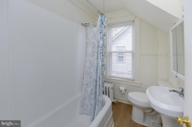 full bathroom with radiator, shower / tub combo with curtain, sink, hardwood / wood-style floors, and toilet