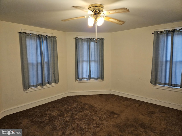 carpeted spare room featuring ceiling fan