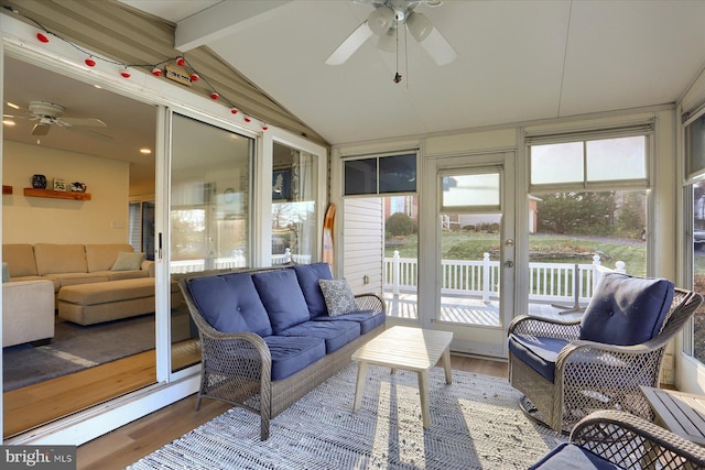 sunroom featuring lofted ceiling with beams and ceiling fan