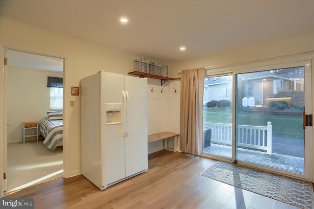 mudroom with plenty of natural light and light hardwood / wood-style flooring