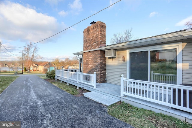 view of side of home featuring a wooden deck