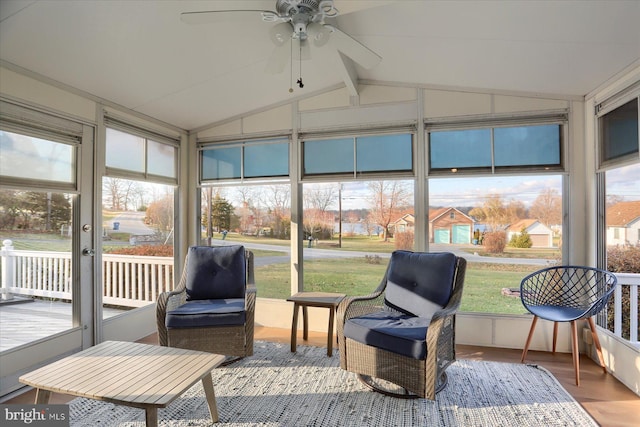 sunroom / solarium featuring ceiling fan, a healthy amount of sunlight, and lofted ceiling