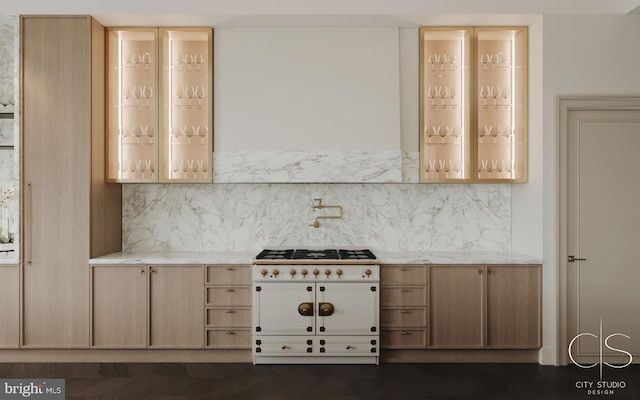 kitchen featuring light brown cabinets, backsplash, and light stone counters