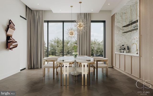 dining room featuring a chandelier, dark parquet flooring, and sink