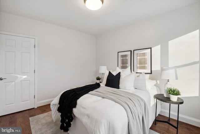 bedroom with dark wood-type flooring