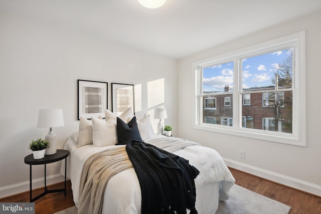 bedroom with dark wood-type flooring