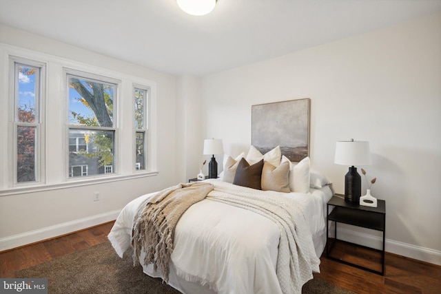 bedroom with dark wood-type flooring