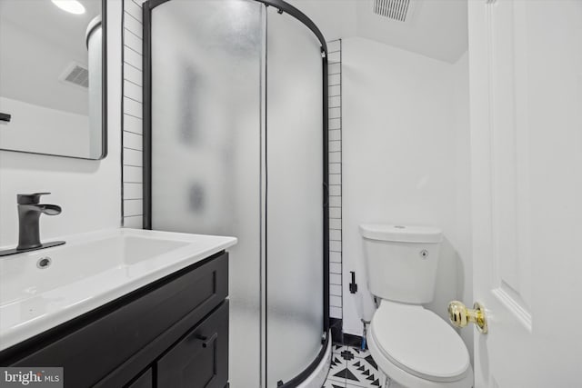 bathroom with vanity, a shower with shower door, and toilet