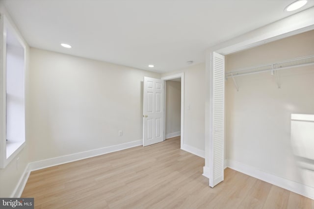 unfurnished bedroom with light hardwood / wood-style floors and a closet