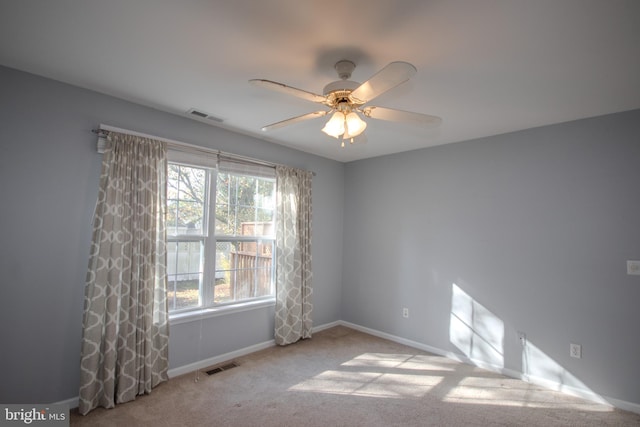 spare room featuring ceiling fan and light colored carpet