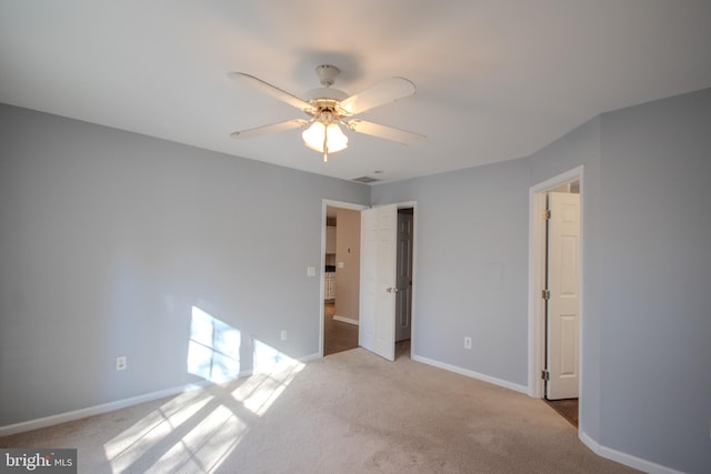 unfurnished bedroom with ceiling fan and light colored carpet