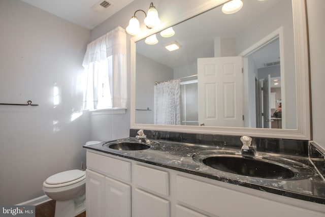 bathroom featuring toilet, vanity, wood-type flooring, and walk in shower