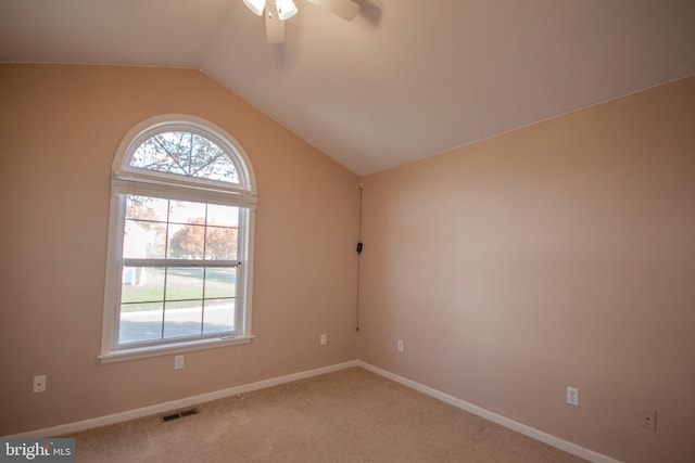 carpeted empty room featuring ceiling fan and lofted ceiling