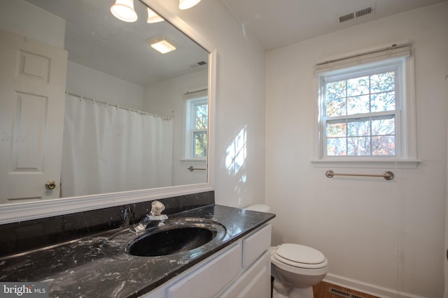 bathroom featuring wood-type flooring, vanity, toilet, and curtained shower