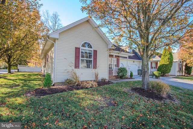 view of front of property with a front lawn and a garage