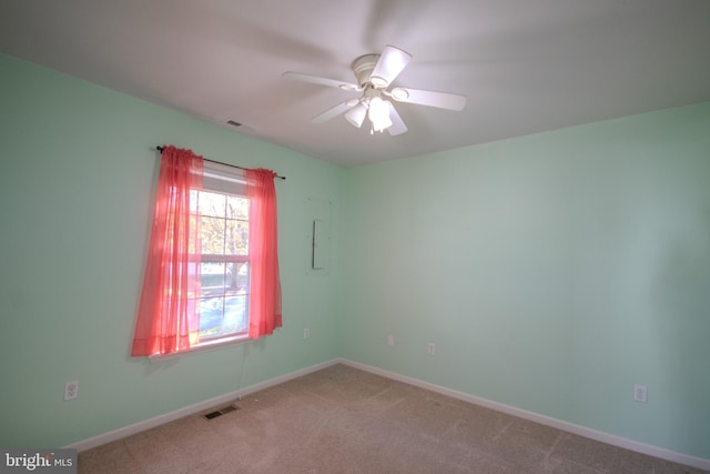 spare room featuring ceiling fan and light carpet