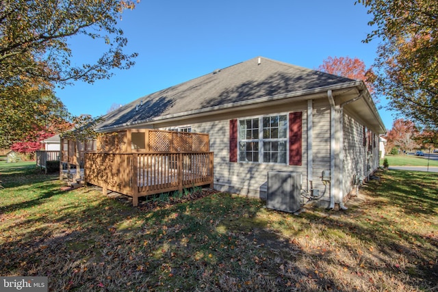 back of property featuring a lawn and a wooden deck