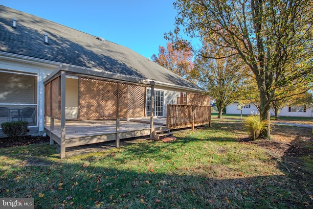 view of side of property with a lawn and a wooden deck