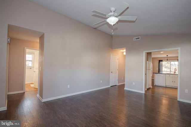 empty room featuring dark hardwood / wood-style floors, vaulted ceiling, ceiling fan, and sink