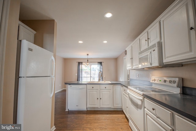 kitchen with kitchen peninsula, light wood-type flooring, white appliances, sink, and white cabinetry